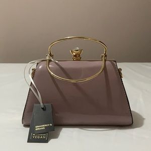 Light pink had bag with gems and gold